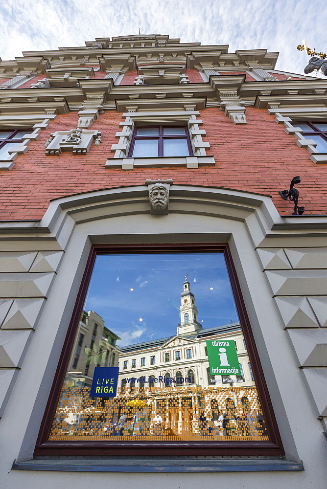 Reflections of downtown in shop window, Riga, Latvia, Europe