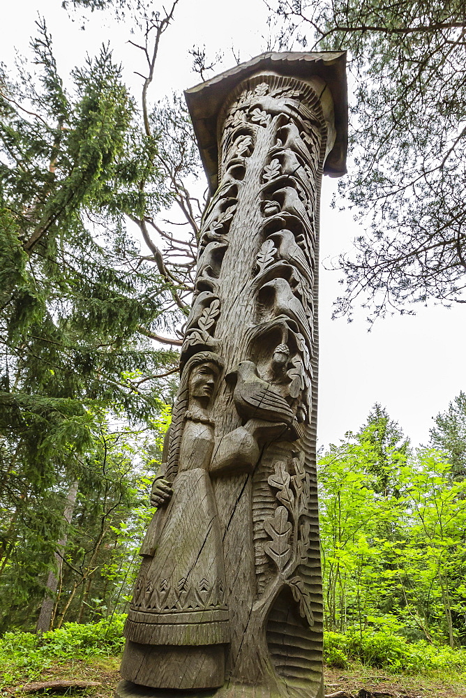 Wood carvings from traditional folklore at The Hill of Witches on the Dano River at the northern tip of the Curonian Spit, Klaipedia, Lithuania, Europe