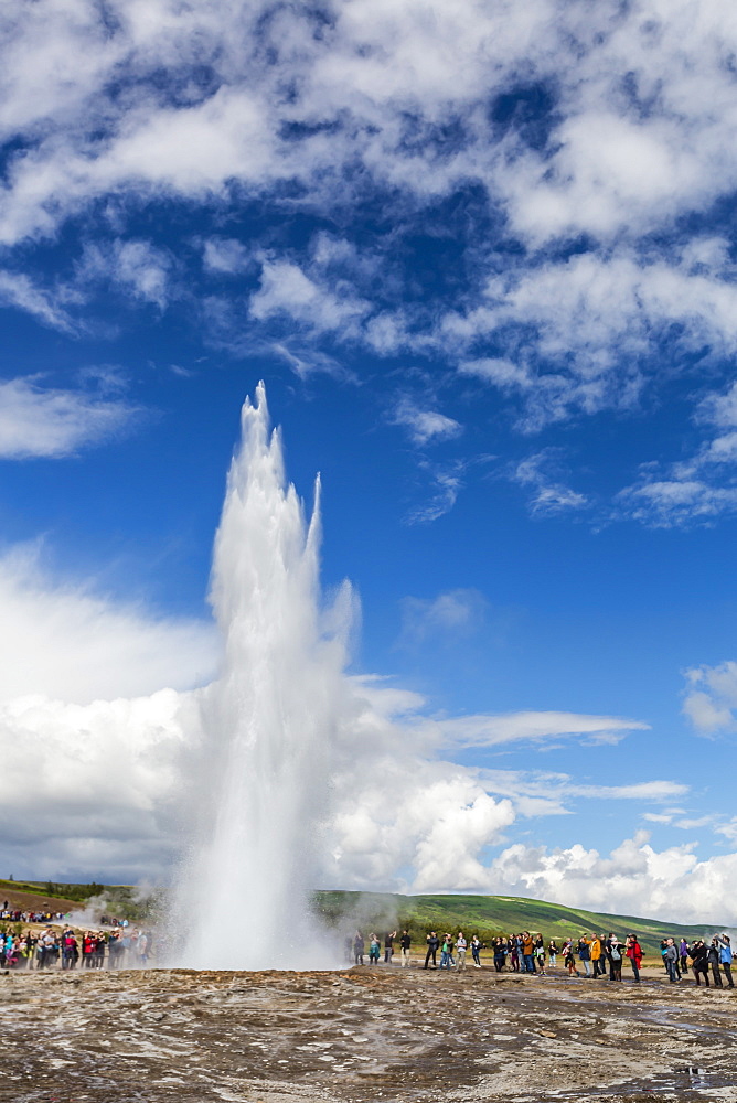 Tourists gather to watch Strokker geyser (geysir), an erupting spring at Haukadalur, Iceland, Polar Regions