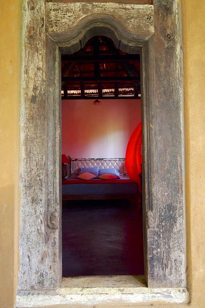 View through the door in a rustic room of the Eco-Resort The Samadhi Center, resort in the mountains near Kandy, Sri Lanka