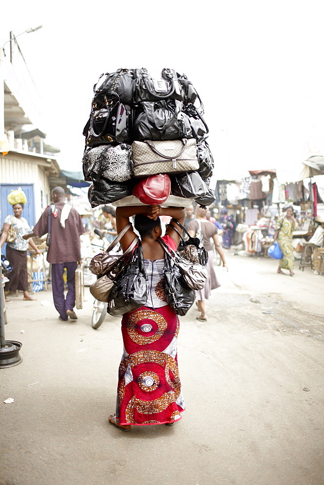 Woman selling handbags at Dantokpa market, Cotonou, Littoral Department, Benin