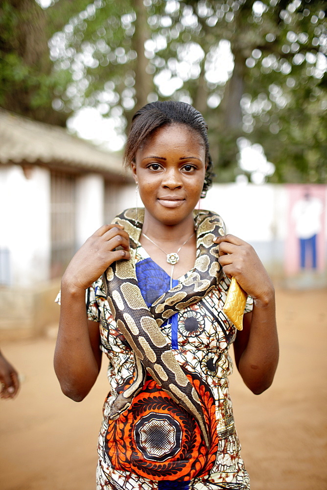 Visitor with snake around her neck, Python temple, Ouidah, Atlantique Department, Benin