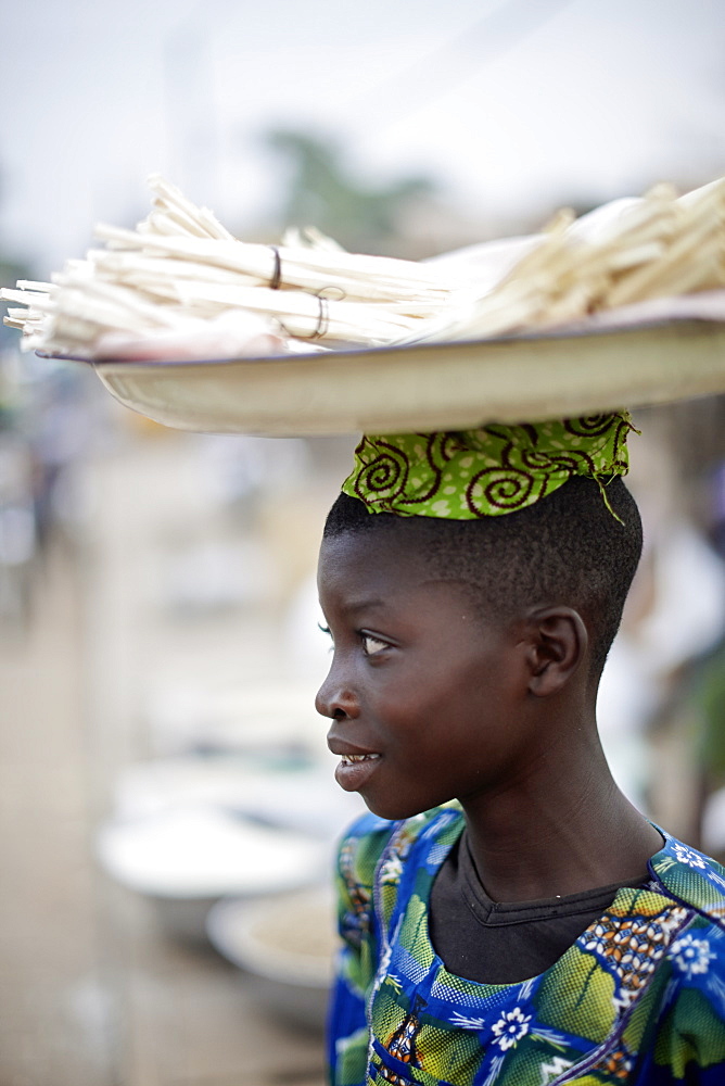 Woman selling softwood to toothbrushing, Dassa market, Benin