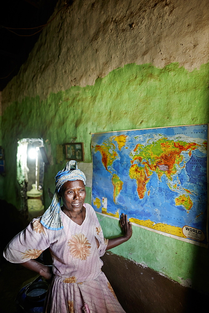 Ethiopian Jewish woman in front of a world map, Walaka, Amhare region, Ethiopia