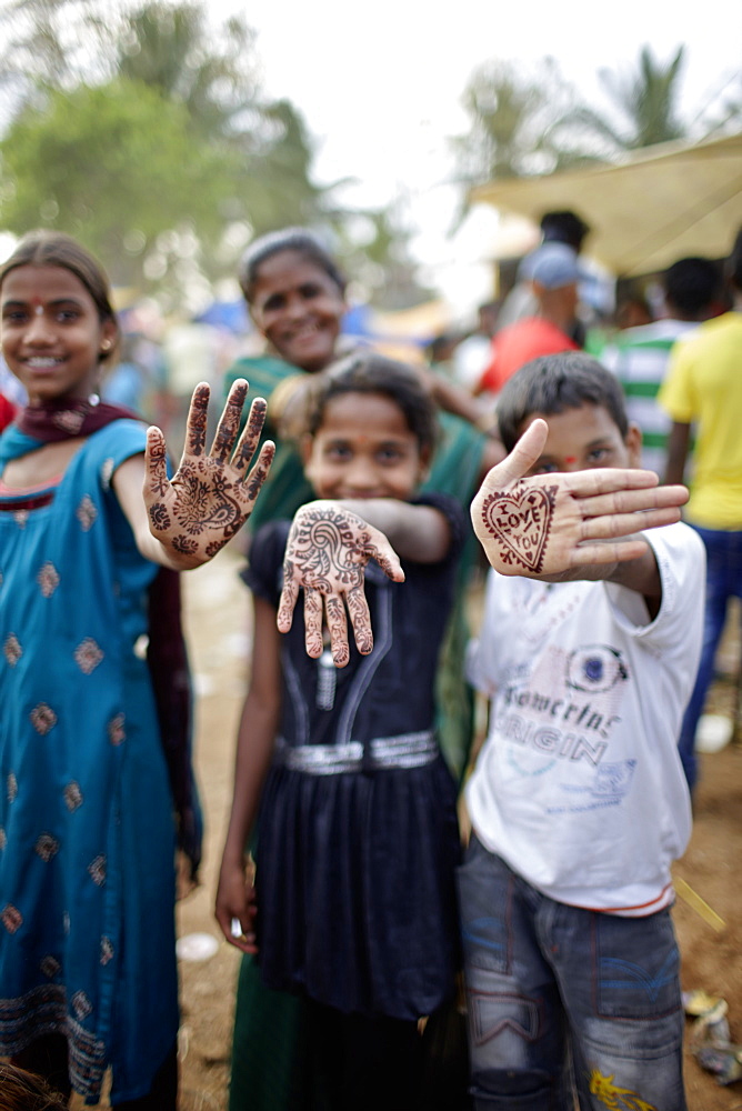 Children with henna painted hands, Angadehalli Belur, Karnataka, India