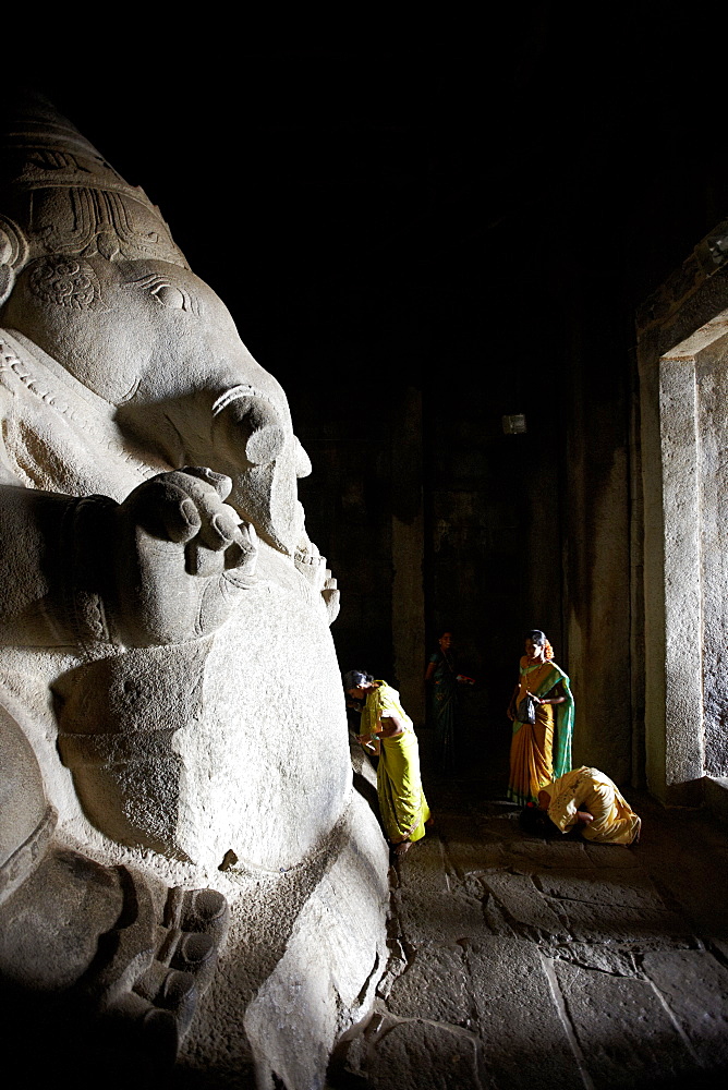 Visitors praying to monolithic Ganesha, Kadalekalu Ganesha temple, Hemakuta Hill, Hampi, Karnataka, India