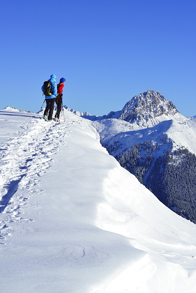 Two female back-country skiers ascending to mount Steinberg, Kitzbuehel Alps, Tyrol, Austria