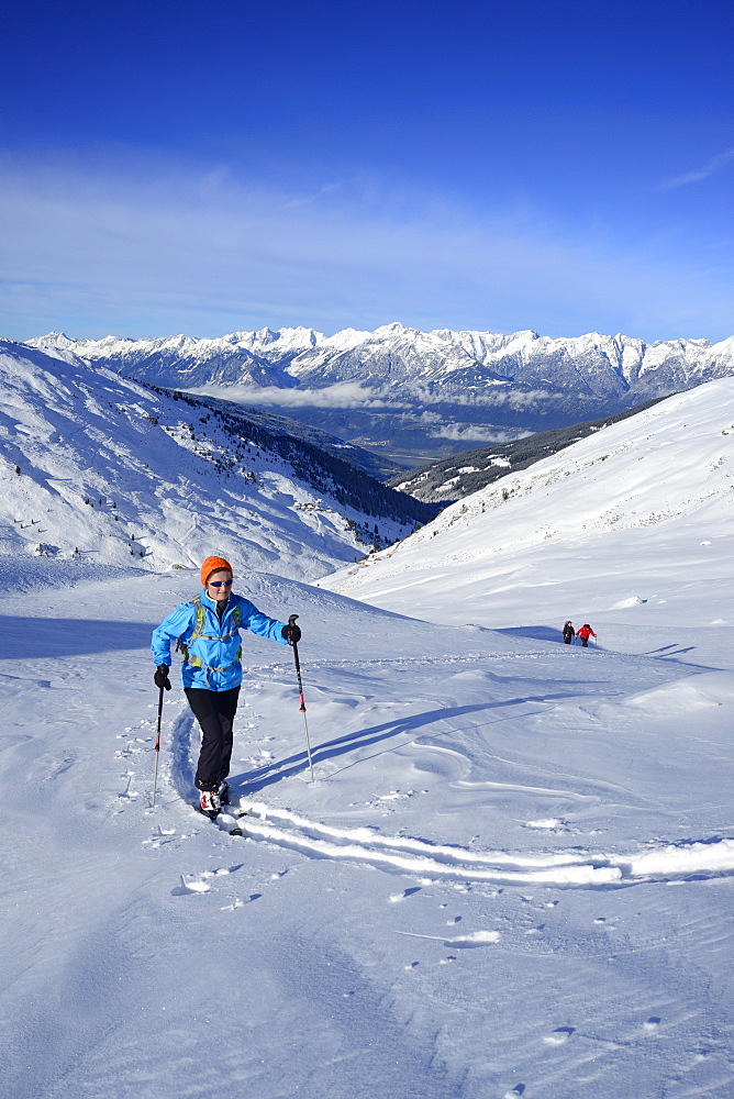 Female back-country skier ascending to Kleiner Gilfert, Karwendel in background, Kleiner Gilfert, Tux Alps, Tyrol, Austria