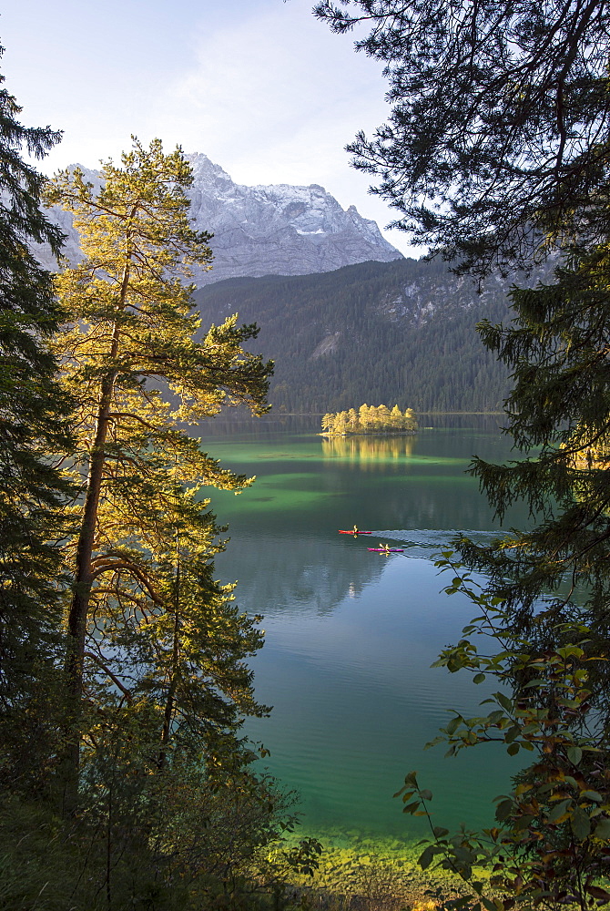 Kayaker paddling on the Eibsee below Zuspitze, Grainau, Bavaria, Germany