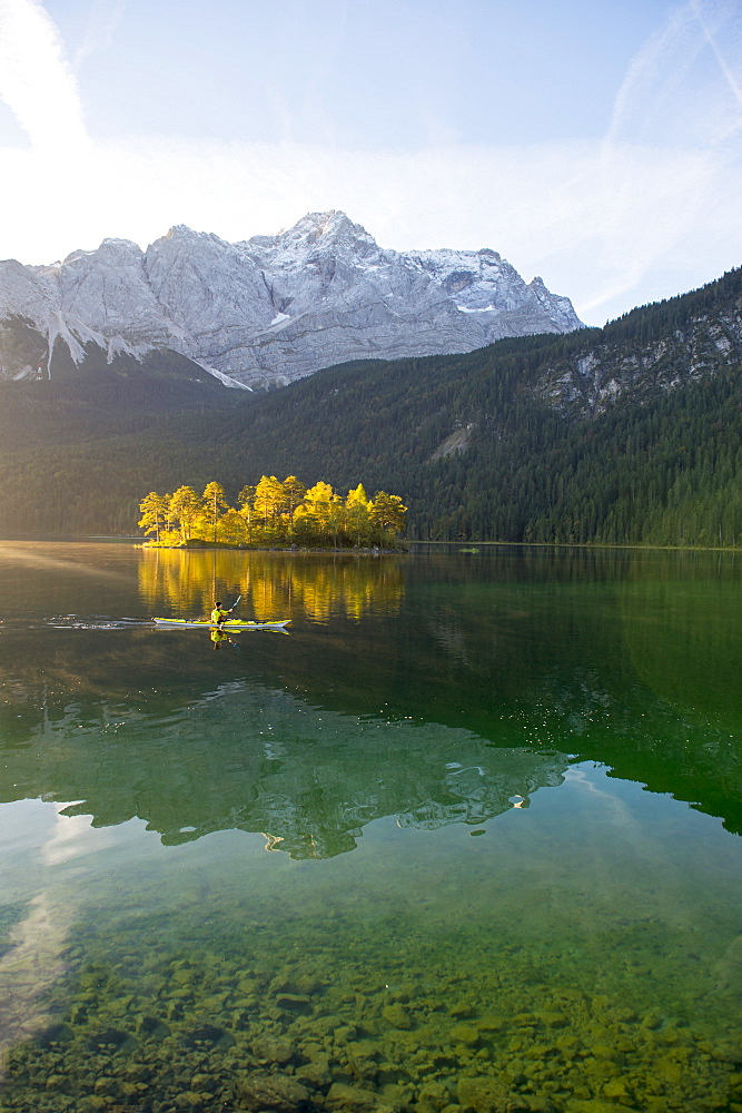 Kayaker paddling on the Eibsee below Zuspitze, Grainau, Bavaria, Germany