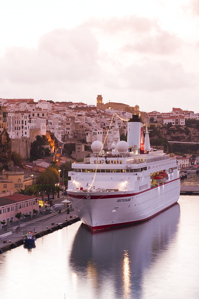 Cruise ship MS Deutschland (Reederei Peter Deilmann) at pier and old town buildings at sunset, Mahon, Menorca, Balearic Islands,