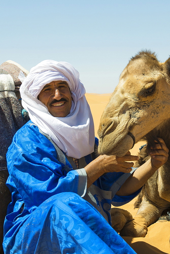 man in traditional clothes and dromedary, Erg Chebbi, Sahara Desert, Morocco, Africa