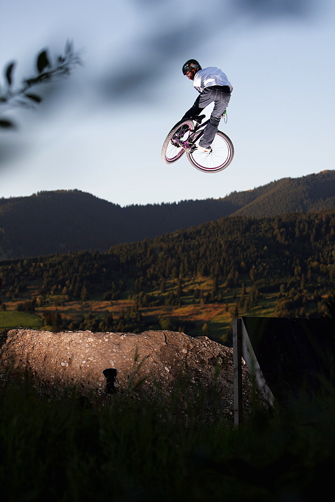 Mountain biker jumping, Oberammergau, Bavaria, Germany