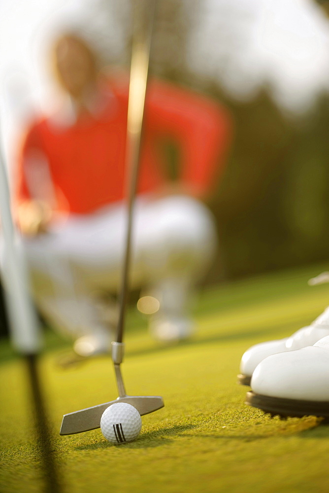 Golfer putting, Strasslach-Dingharting, Bavaria, Germany