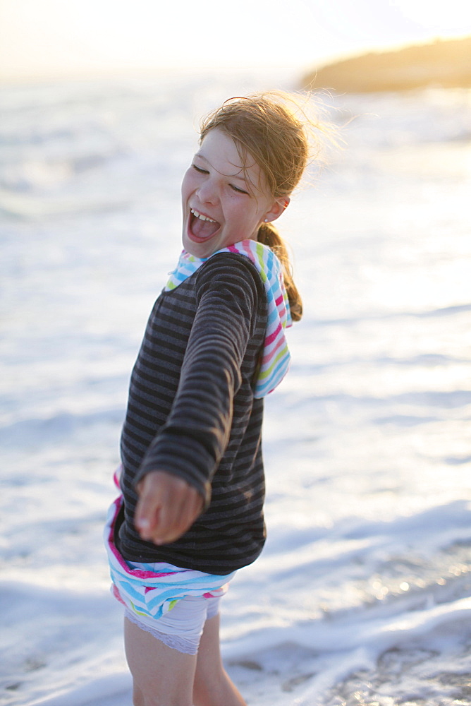 Girl on the beach in the evening light, laughing, Es Arenals, Formentera, Balearic Islands, Spain