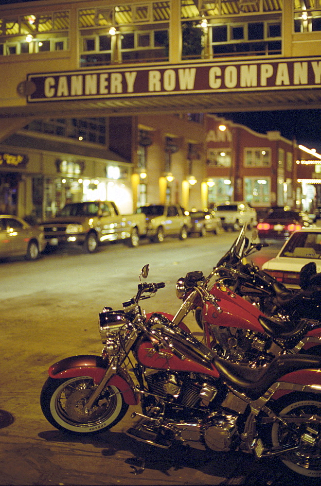 Motor bikes and cars parking at Cannery Road at night, Monterey, California, USA, America