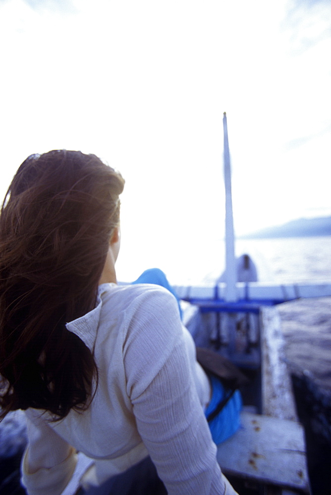 Woman on small fishing boat, Lovina Beach, Bali, Indonesia