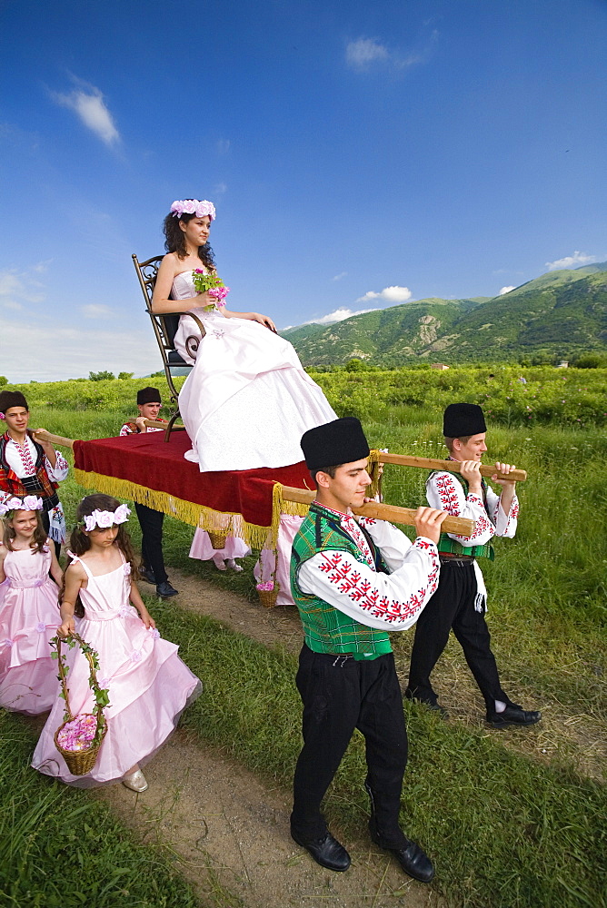 Rose Queen, young woman is carried in a sedan, Rose Festival, Karlovo, Bulgaria, Europe