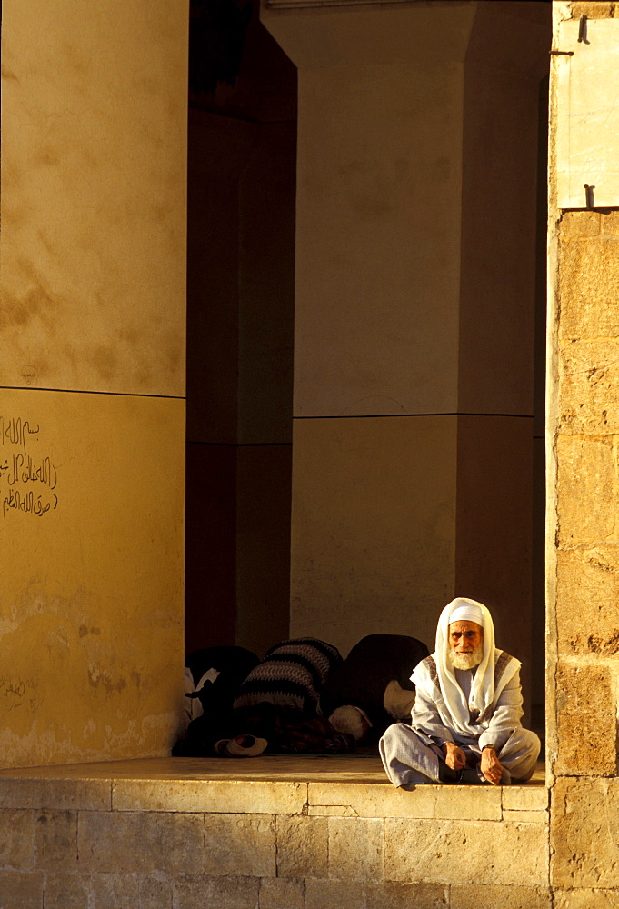 Man sitting in front of the Omayyaden Mosque, Aleppo, Syria