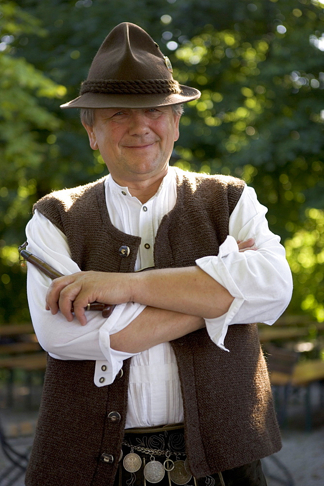 Older Bavarian man with pipe wearing traditional clothes, Munich, Bavaria