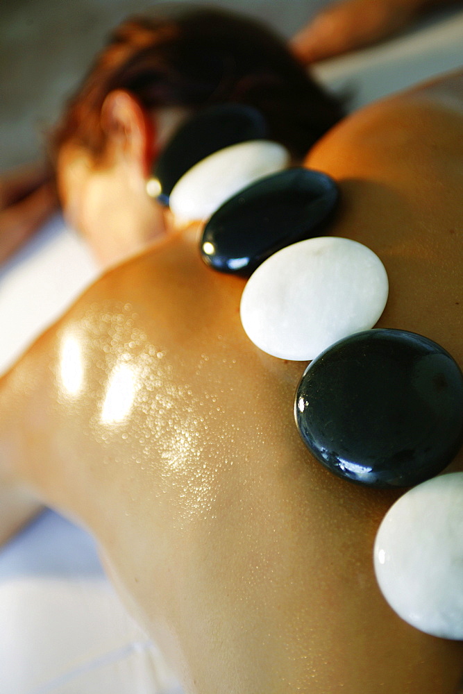 Girl having a massage with stones, Girl having a massage with stones, Young women having a stone massage, Wellness Spa Massage Beauty