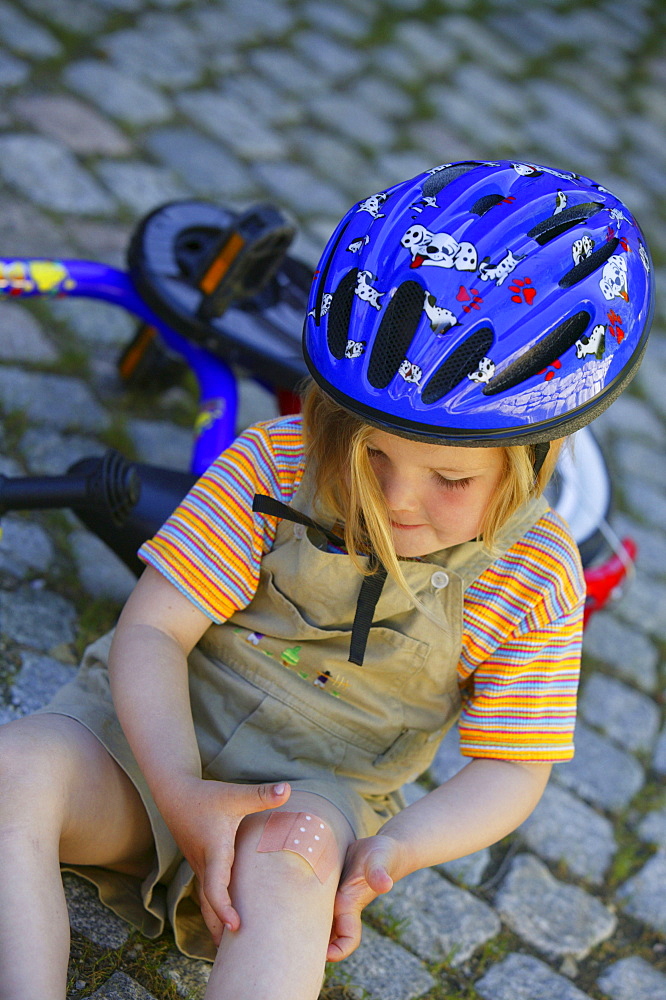 Girl showing an adhesive bandage on her Knee