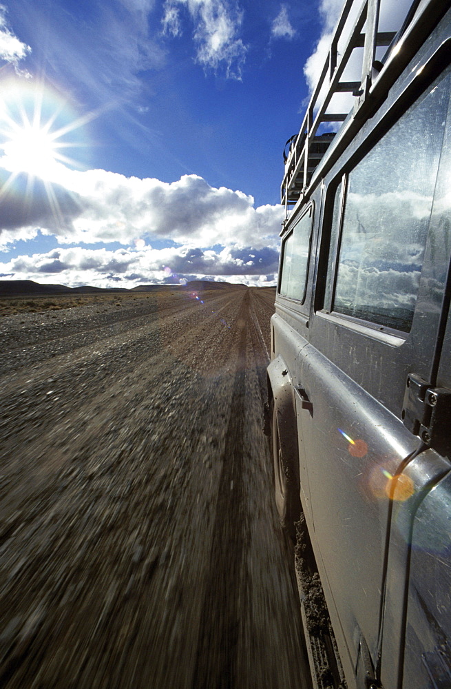 Car on road in lonesome landscape, Rio Mayo, Argentina, South America, America