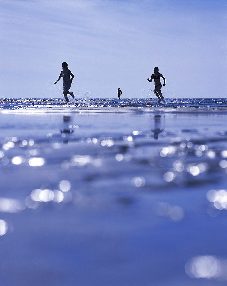 People running at the beach