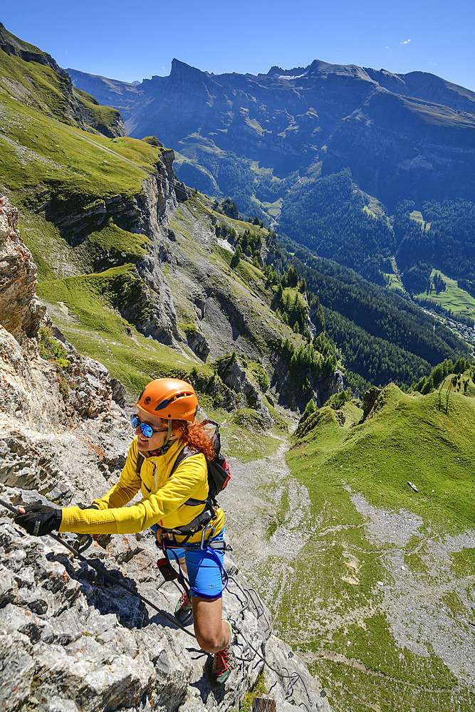 Woman climbs on the Gemmi adventure via ferrata, Gemmi, Bernese Alps, Valais, Switzerland