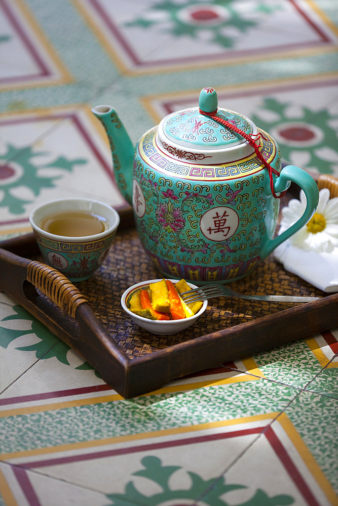 Chinese tea arrangement set on a Nonya style, tile floor. Malacca, Malaysia.