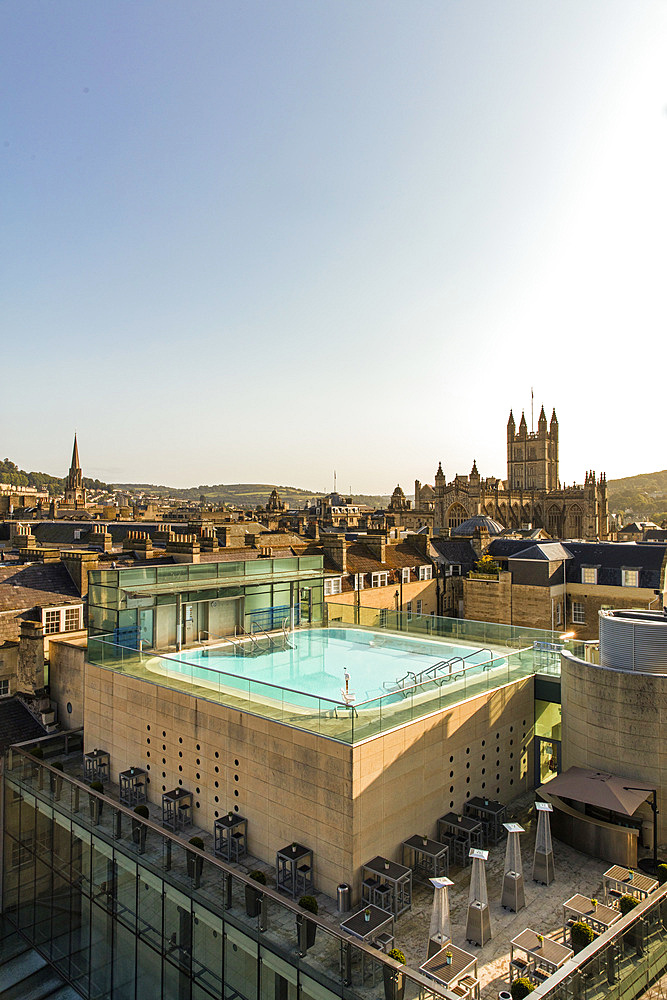 View of exterior roof-top pool set against the scenery of old turrets and buildings. Vertikal. Bath. United Kingdom