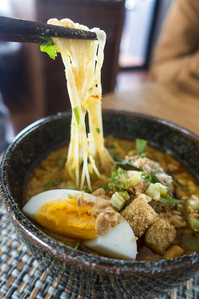 Delicious bowl of soup with noodles is served for lunch on board of river cruise ship, Mekong river, near Chau Doc, An Giang, Vietnam, Asia