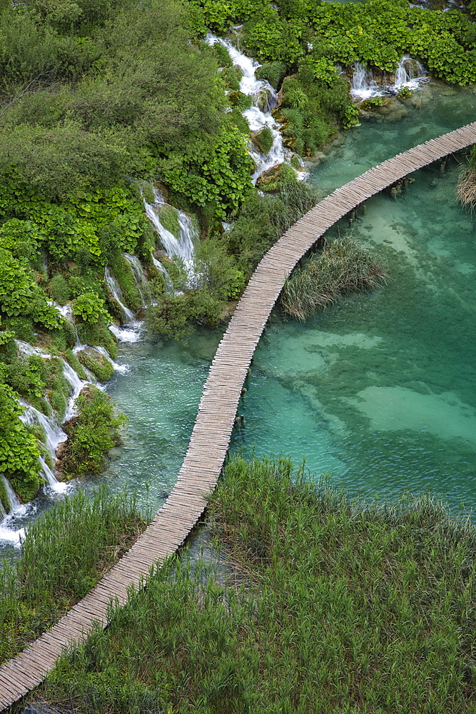 View of wooden plank path over pool with waterfalls, Plitvice Lakes National Park, Lika-Senj, Croatia, Europe