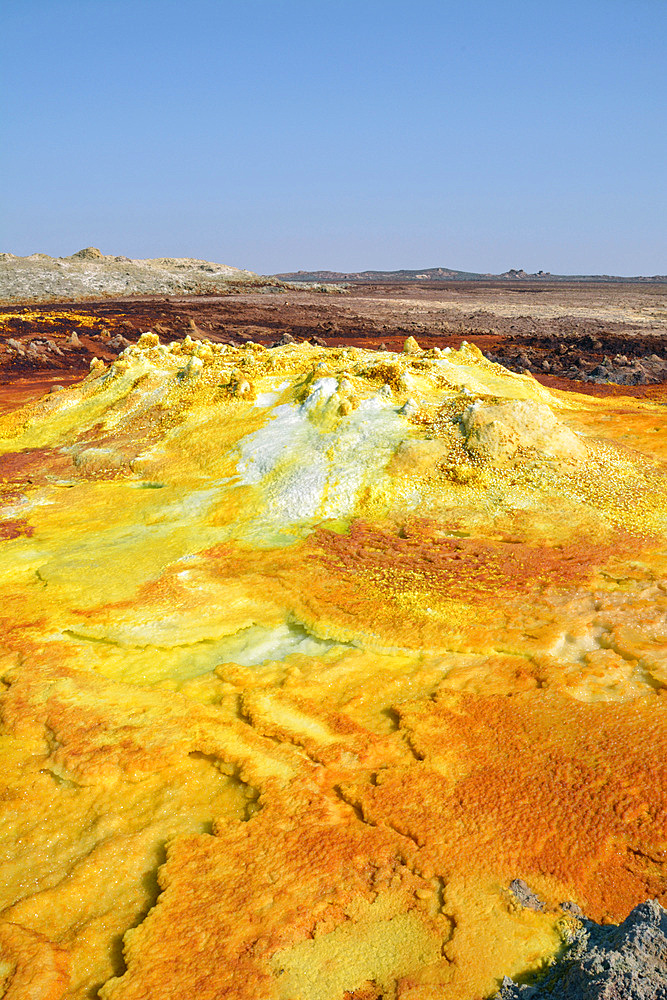 Ethiopia; Afar region; Danakil Desert; Danakil Depression; Dallol geothermal area; hot sulfur springs; cone-like formation in intense yellow, red and green tones