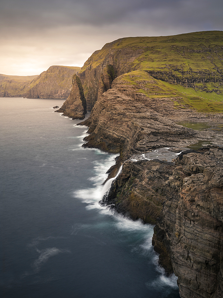 Coast, waterfall and cliffs at Trælanípa on the island of Vagar, on Lake Leitisvatn, Faroe Islands