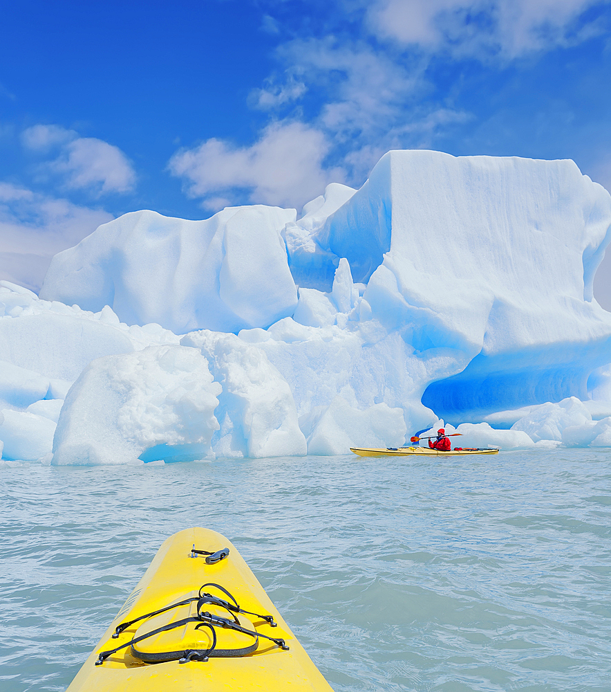 Kayaker paddling near icebergs, Torres del Paine National Park, Chile, South America