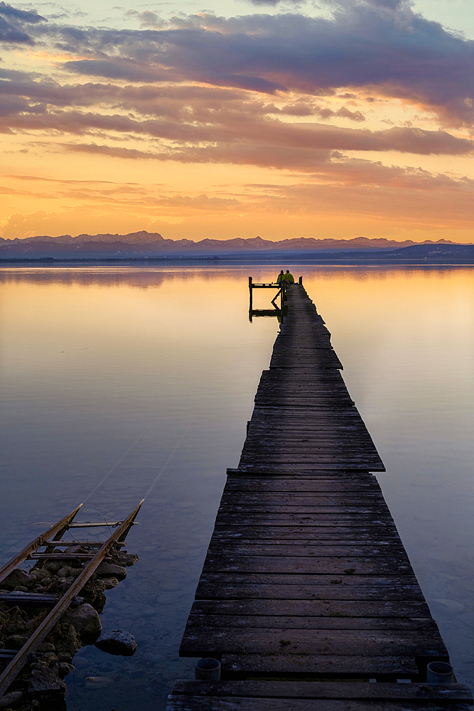 A couple enjoys the evening mood at Ammersee, Fünfseenland, Bavaria, Germany