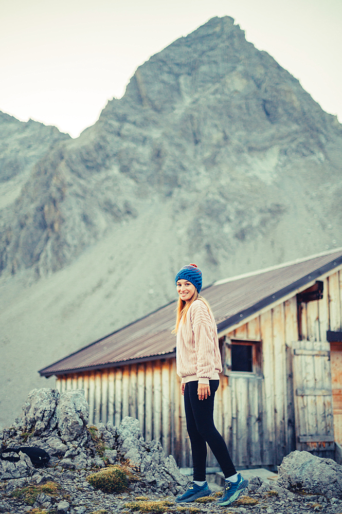 Woman stands at the Totalphütte in the Rätikon above the Lünersee, Vorarlberg, Austria, Europe