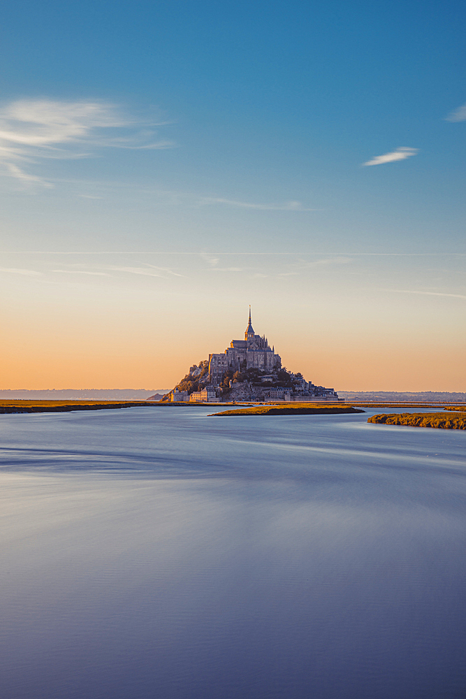 Evening view of the rocky island of Mont Saint Michel with the monastery of the same name, Normandy, France.