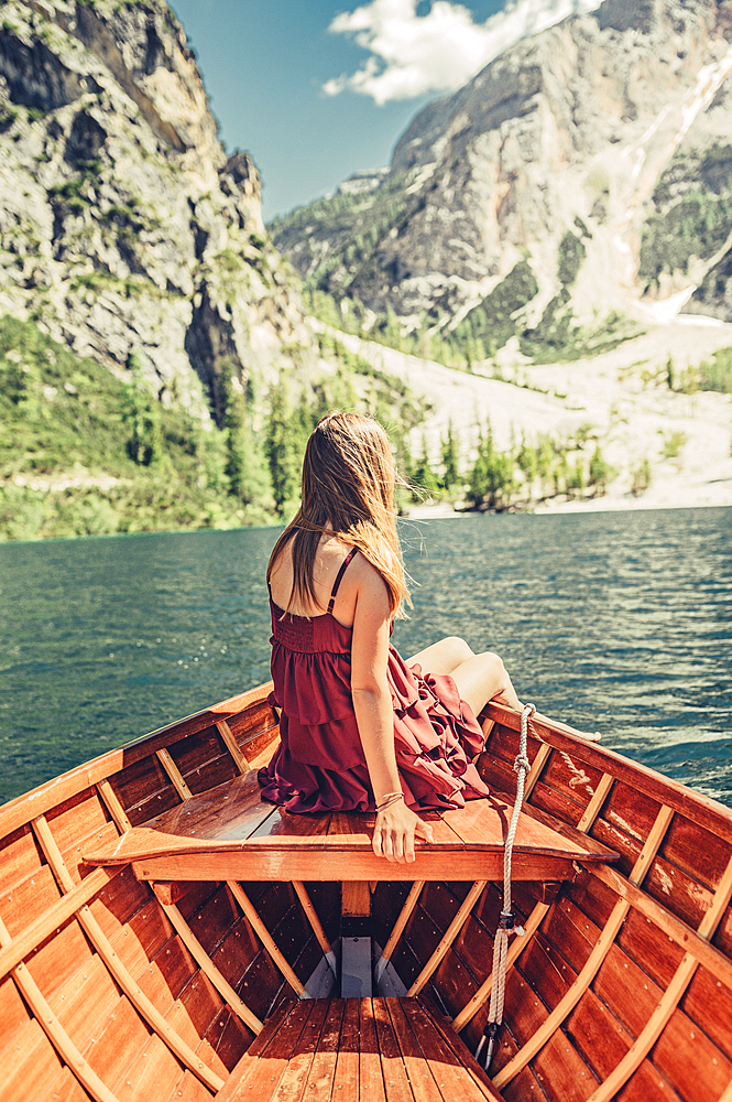 Woman on a boat trip on Lake Braies amid the Dolomites in South Tyrol, Italy, Europe