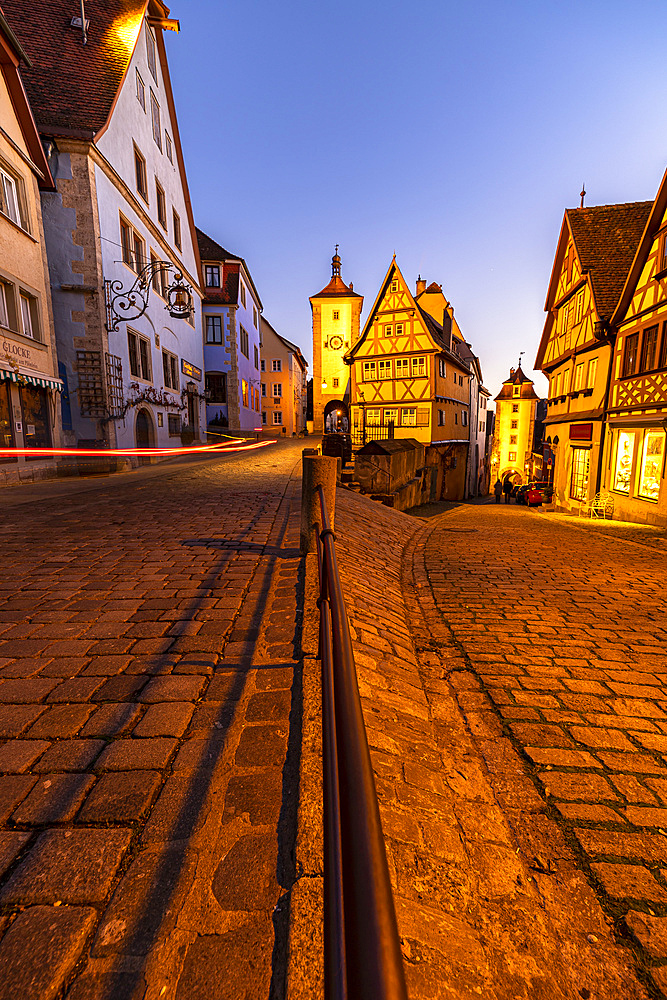 Famous fork "Plönlein" at the blue hour with light streaks from car in Rothenburg ob der Tauber, Middle Franconia, Bavaria, Germany