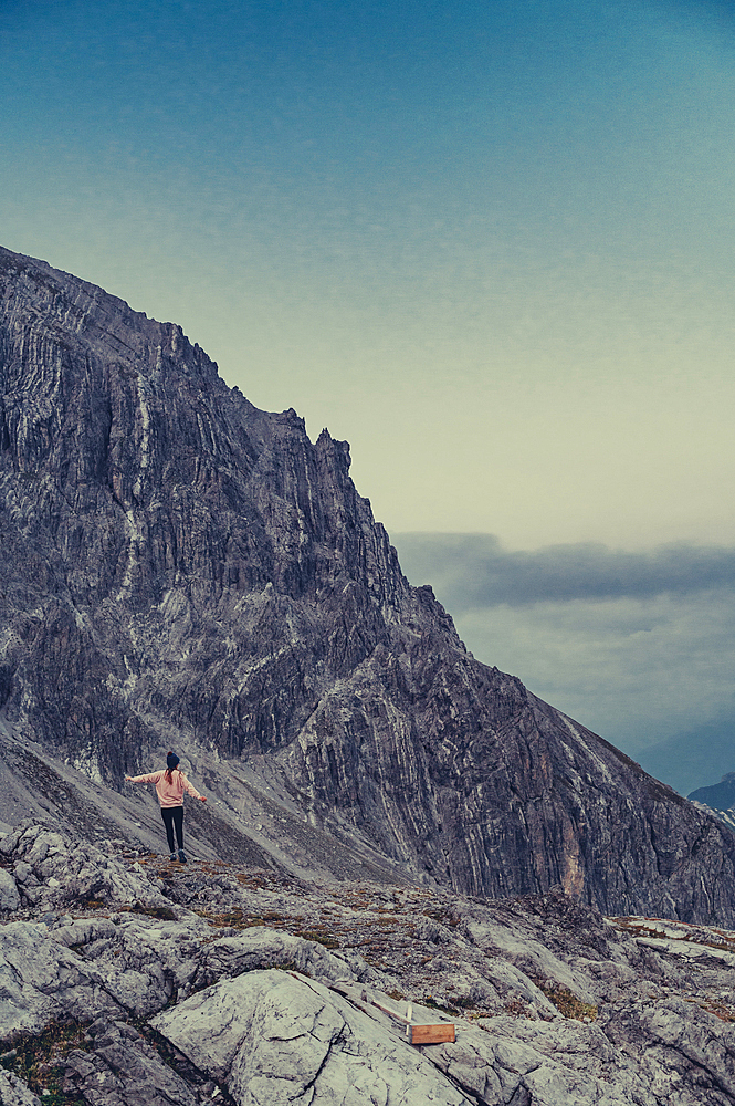 Woman stands in the mountains in the Rätikon above the Lünersee, Vorarlberg, Austria, Europe