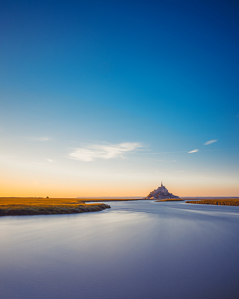 Evening view of the rocky island of Mont Saint Michel with the monastery of the same name, Normandy, France.