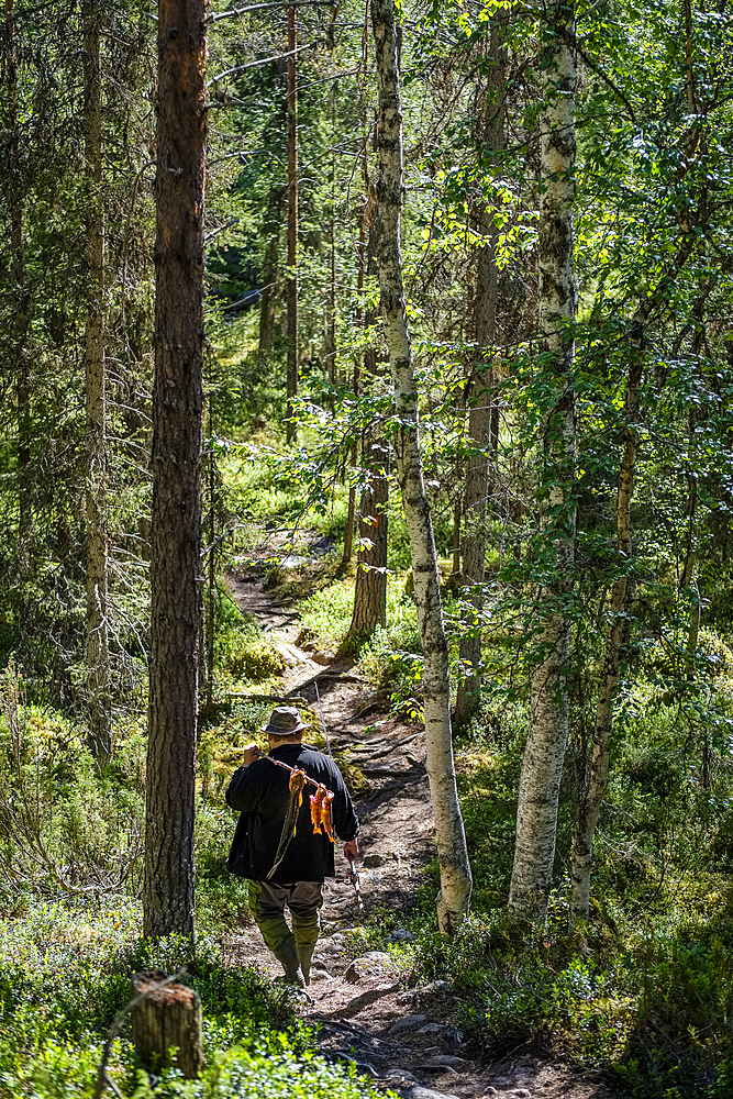 At the Rupkivi characteristic rock in the Savinajoki river, anglers on the Bear Circle hiking trail, Finland