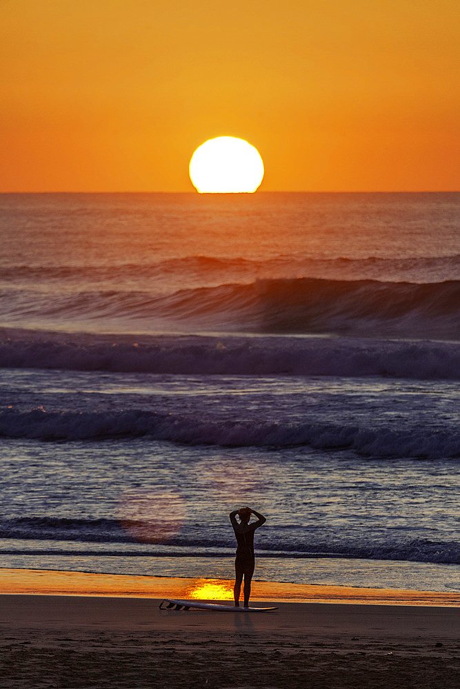 Europe, Portugal, Algarve, sunset, Atlantic, surfer looking at the sea