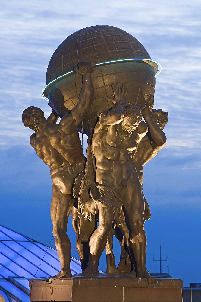 Atlas figures on roof of Museum for Communication at night, Berlin