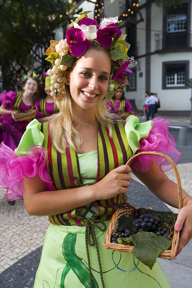 Young woman in colourful costume at the Madeira Wine Festival, Funchal, Madeira, Portugal