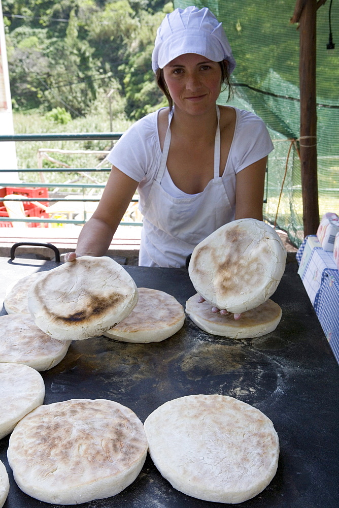 Woman baking Bolo de Caco, Flatbread, Serra de Agua, Madeira, Portugal