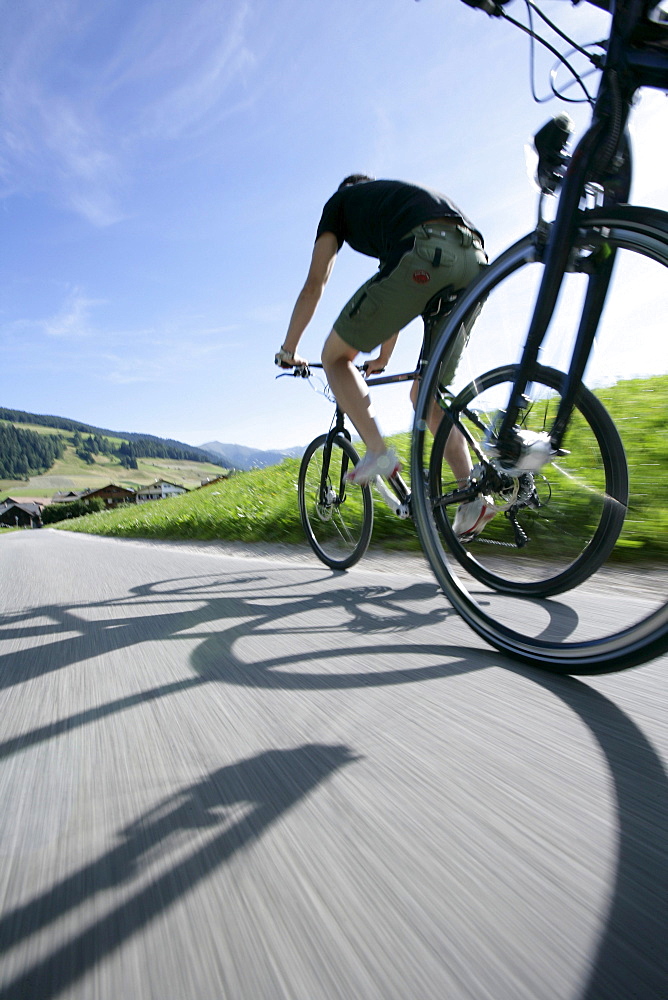 Persons mountain biking near Tre Cime di Lavaredo, Veneto, Italy