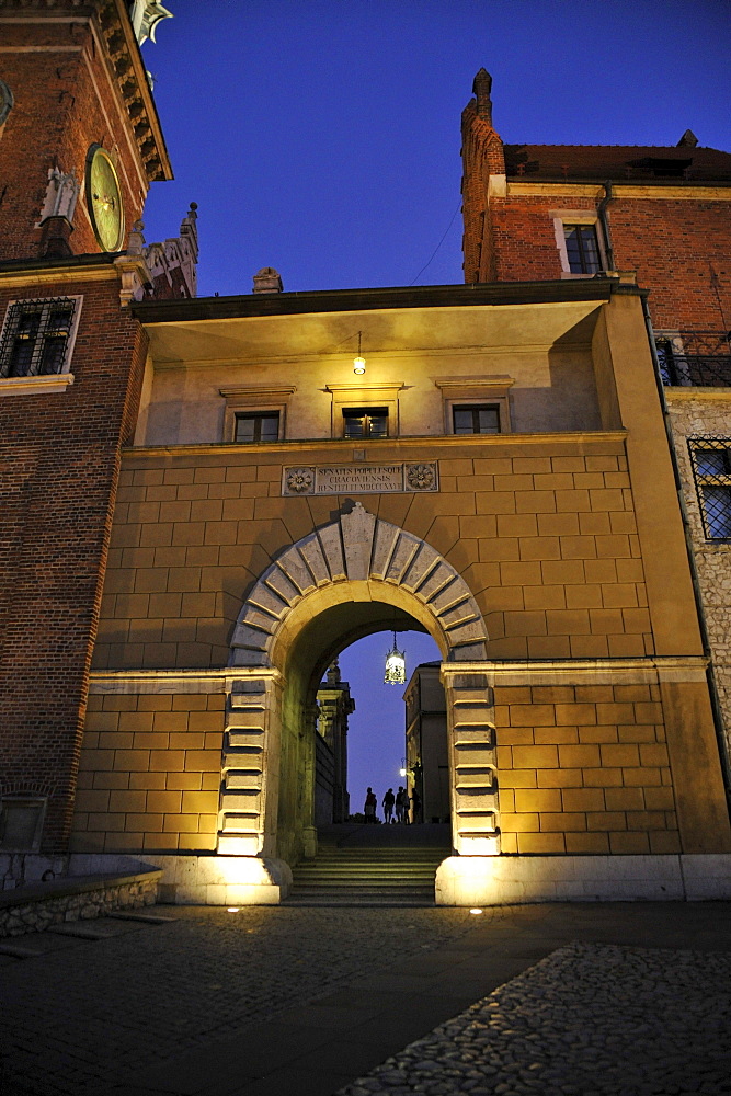 Illuminated gate to Wawel cathedral, Krakow, Poland, Europe